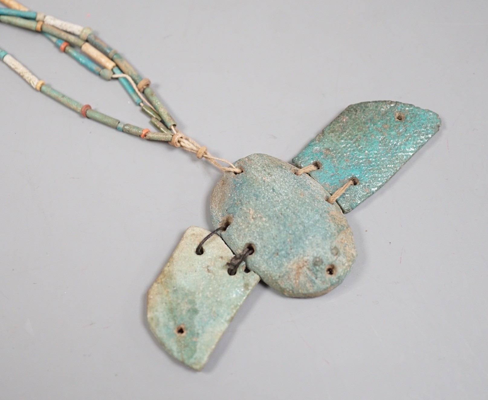 An Egyptian turquoise glazed faience scarab pendant, and cylindrical beads, probably New Kingdom